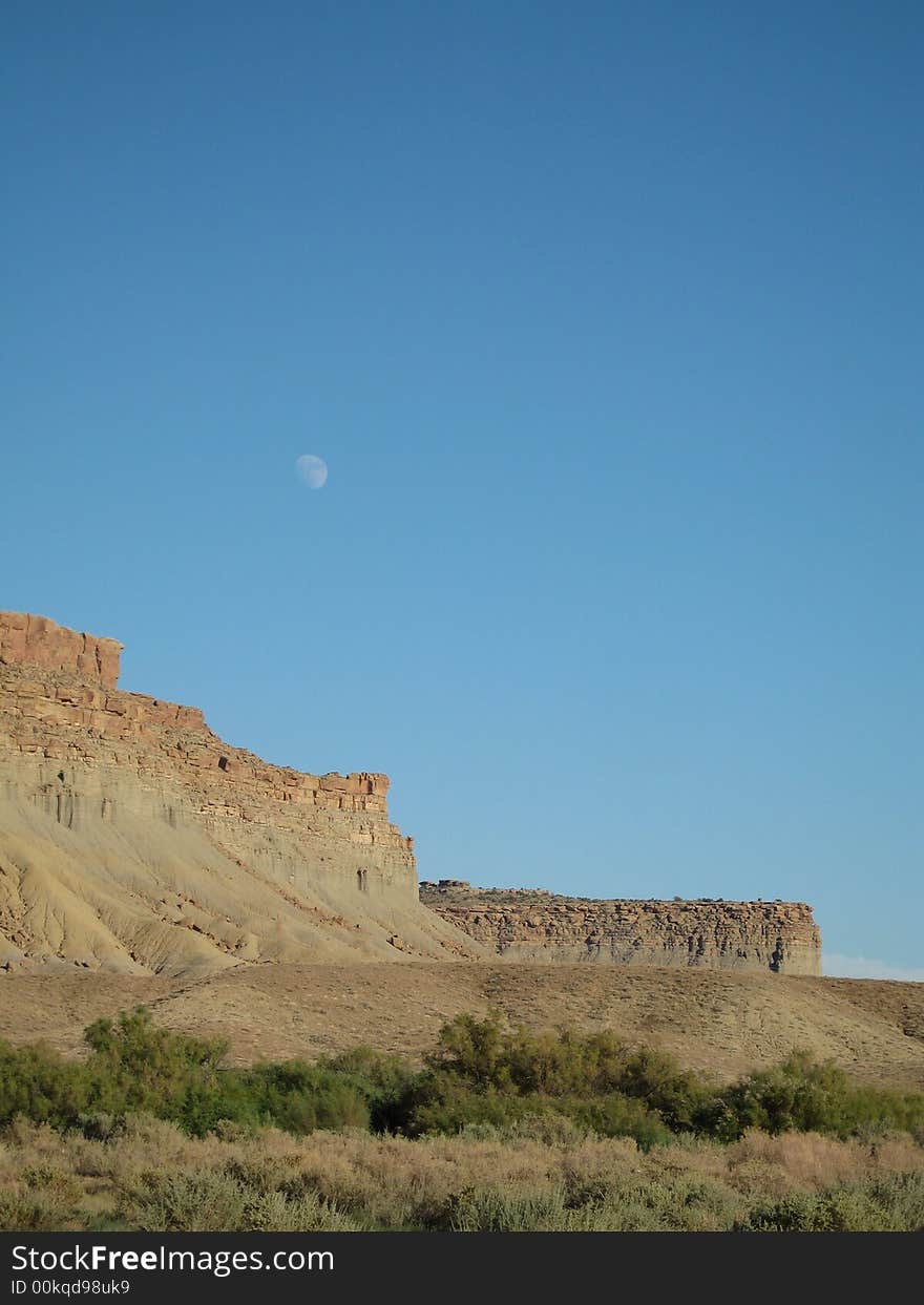 This late afternoon shot captured the moon rising over a Colorado Mesa. This late afternoon shot captured the moon rising over a Colorado Mesa