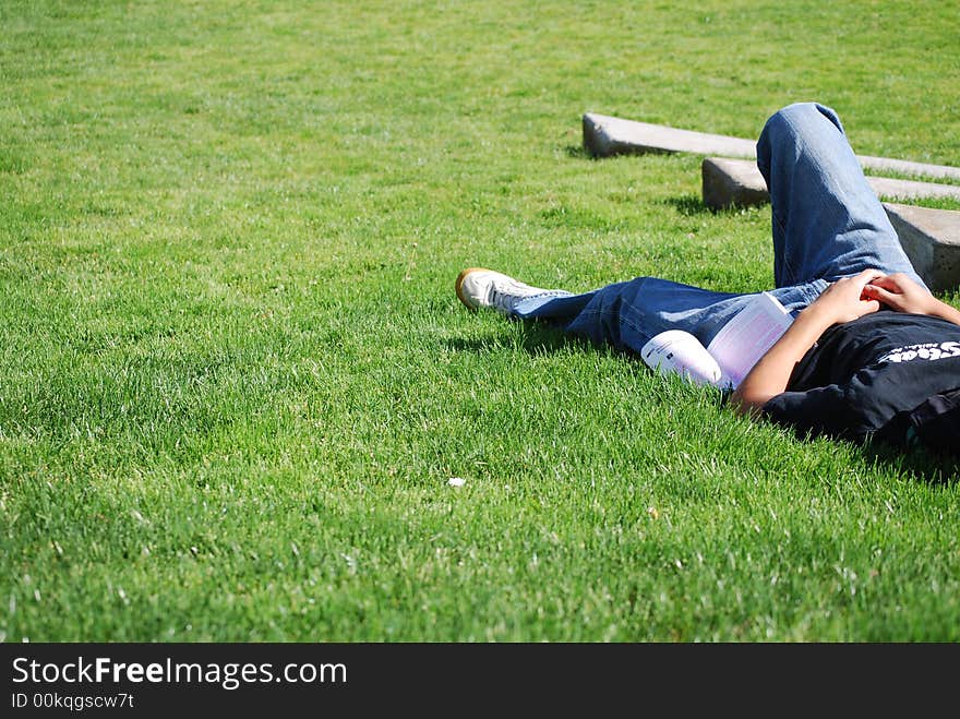 Someone taking break in the park after study hard at school. Someone taking break in the park after study hard at school