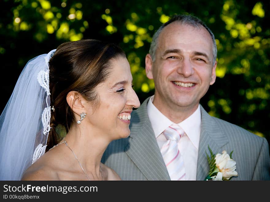 A just married man and woman by some trees. A just married man and woman by some trees