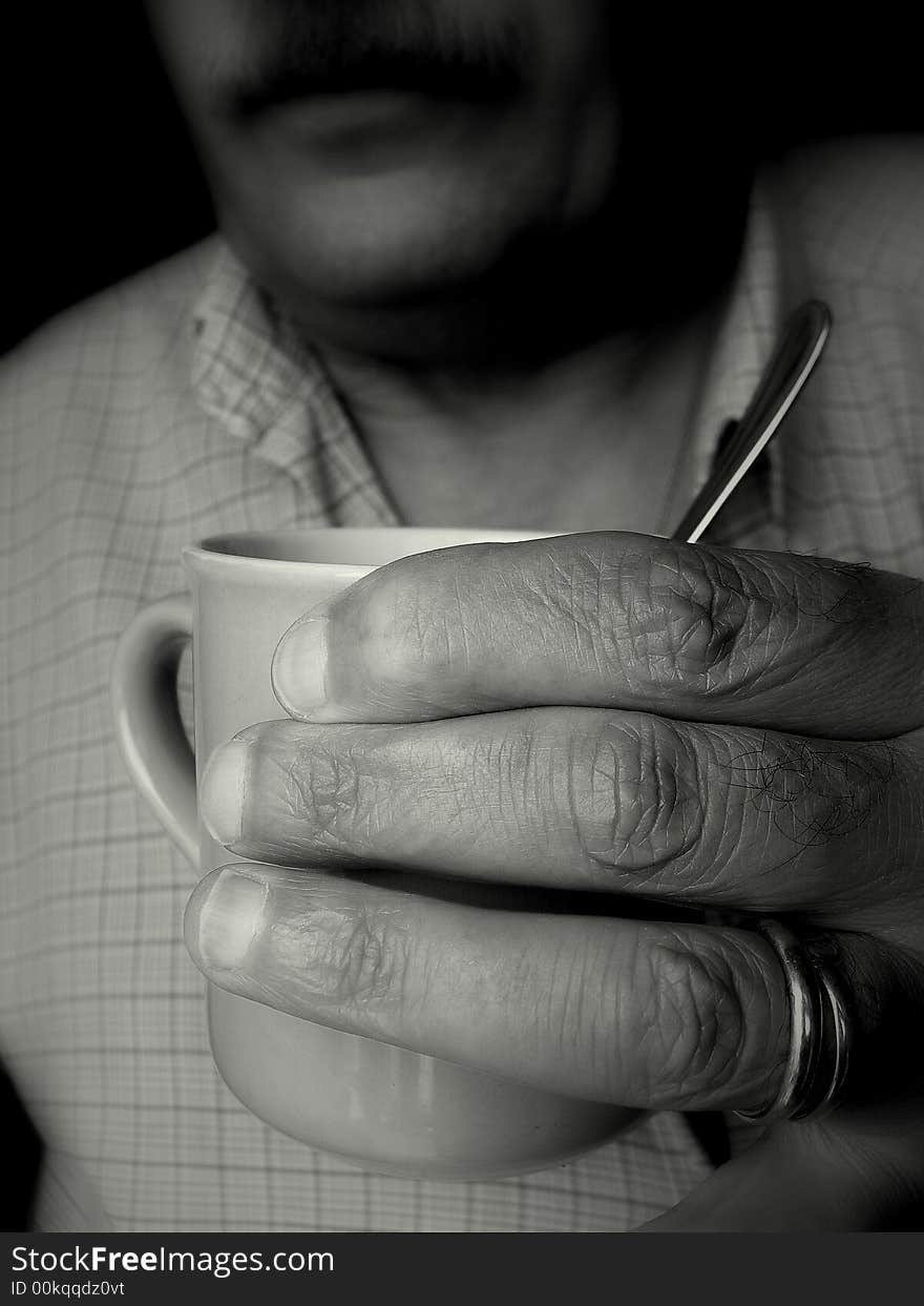 One hand with a cup of tea