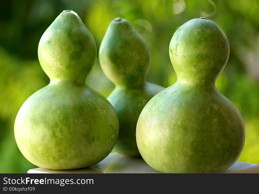 Three small green pumpkins (calabashes).