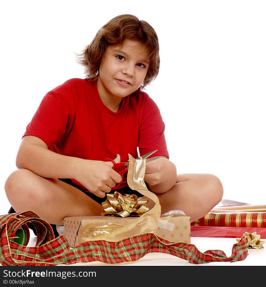 Elementary girl wrapping gifts to give at Christmas.  Isolated on white. Elementary girl wrapping gifts to give at Christmas.  Isolated on white.