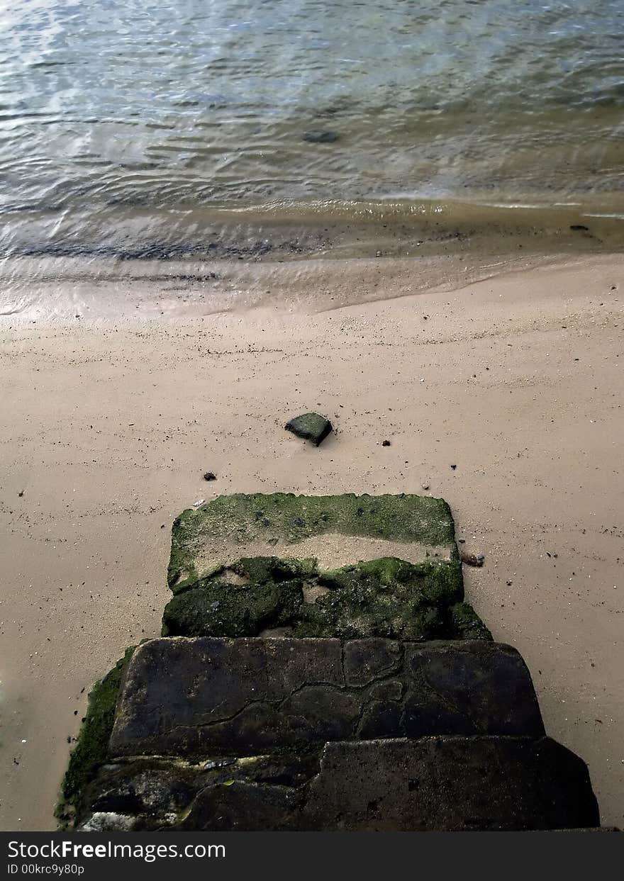 Flight of steps of weathered concrete leading down to a shore. Flight of steps of weathered concrete leading down to a shore.