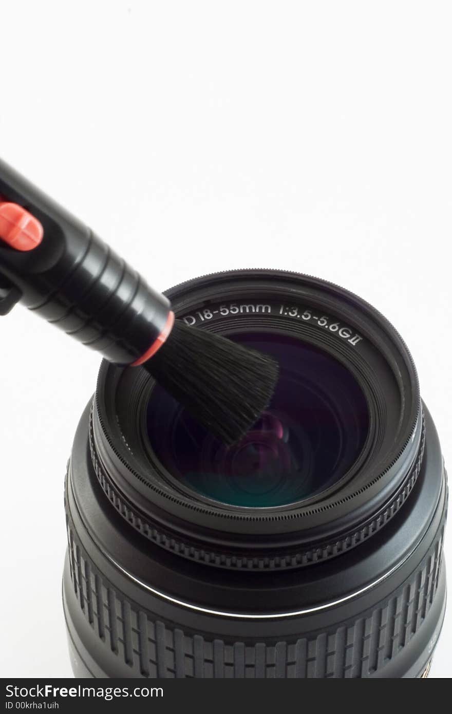 The object-glass with brush photographed on a white background