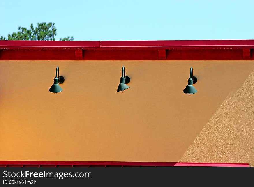 Green lights on a bright yellow and red wall. Green lights on a bright yellow and red wall