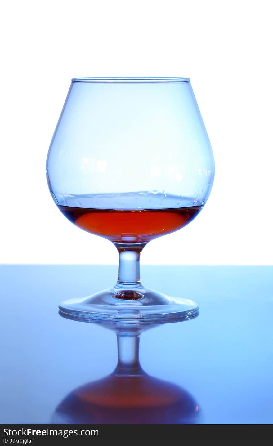 Glass with cognac on white background. Glass with cognac on white background