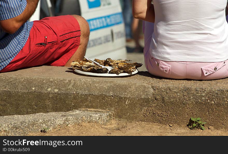 A couple eating oysters at street