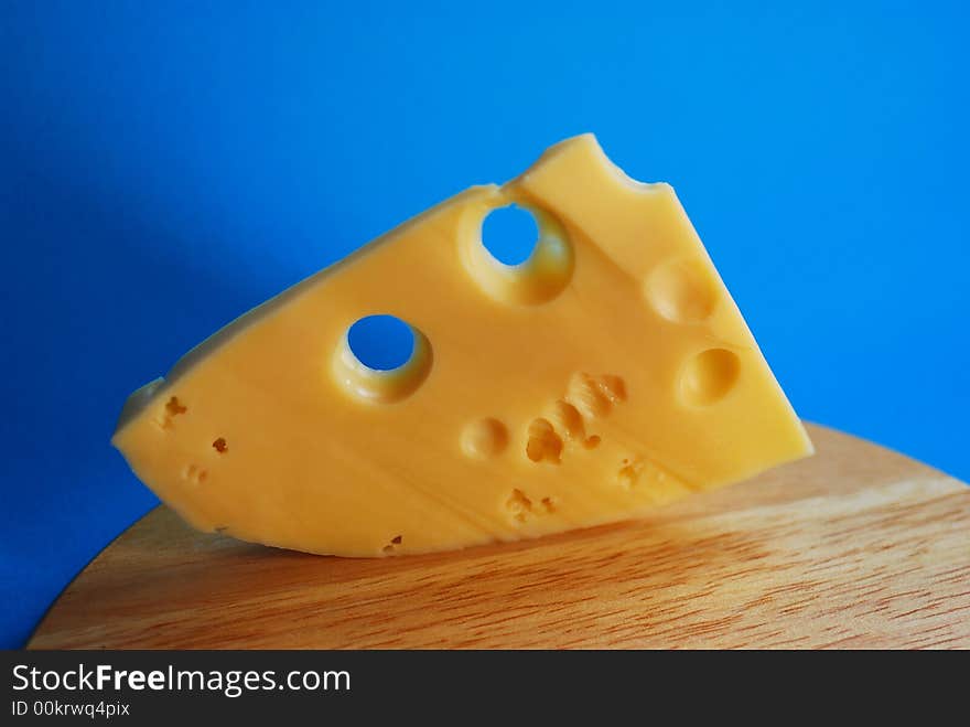 Piece of cheese on a blue background