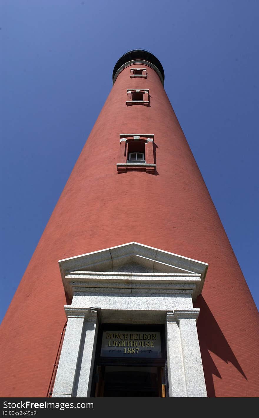 Low angle view of Ponce Inlet lighthouse with blue sky background, Florida, U.S.A.