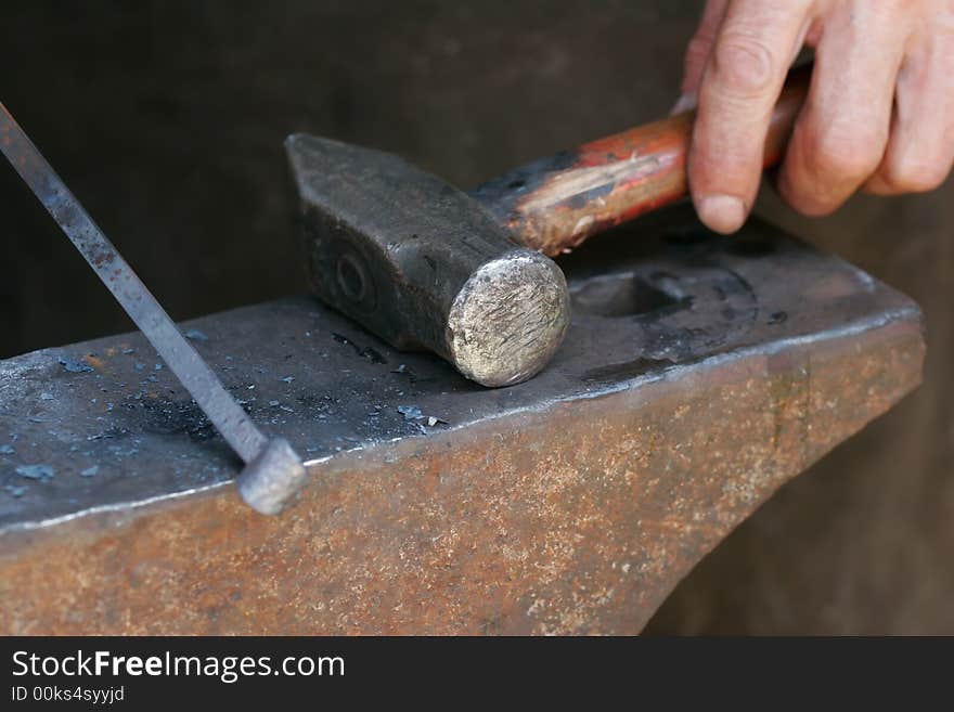 A balcksmith handling his hammer and iron rod. A balcksmith handling his hammer and iron rod.