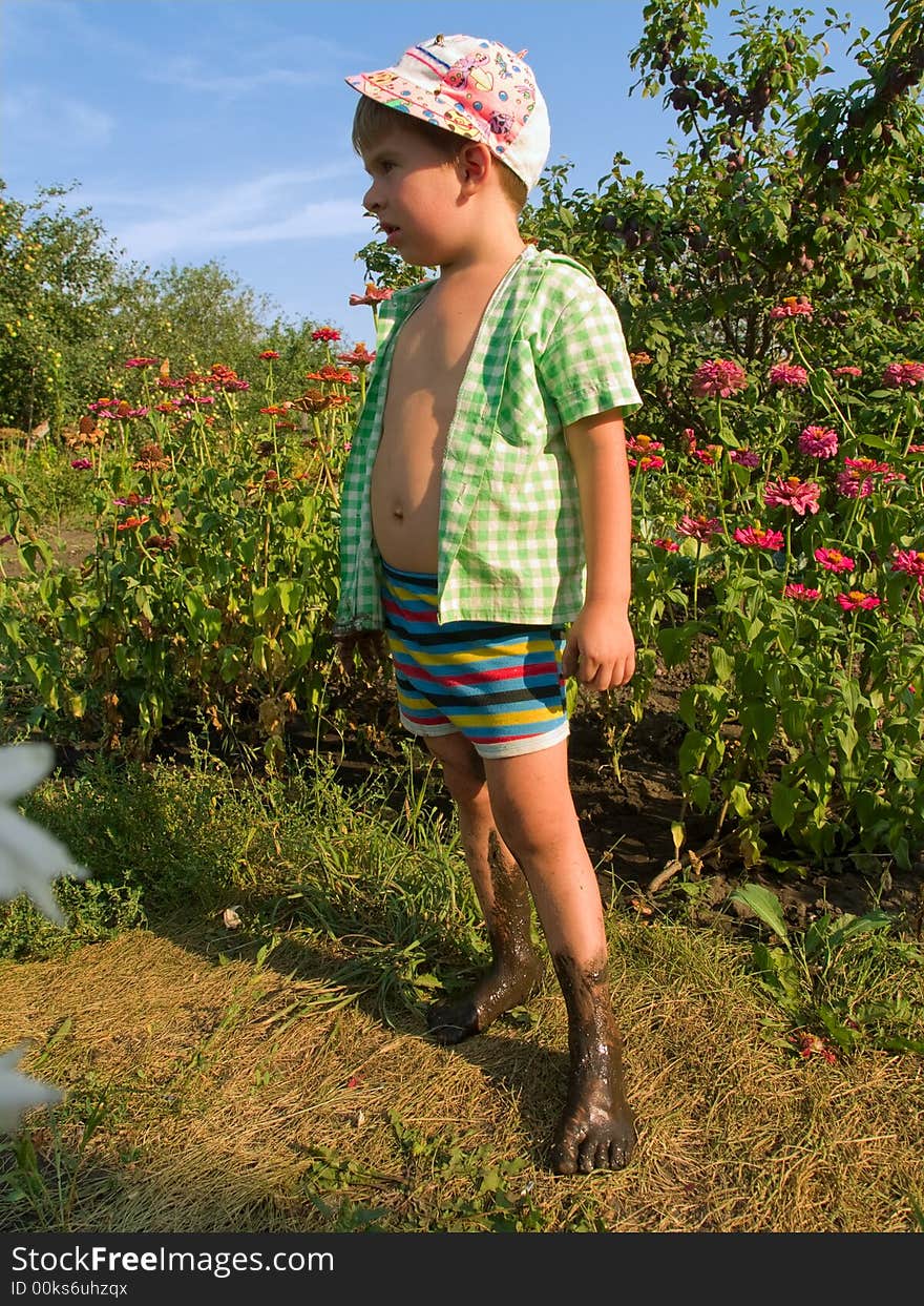 Outdoor summer scene with little boy and flowers. Outdoor summer scene with little boy and flowers