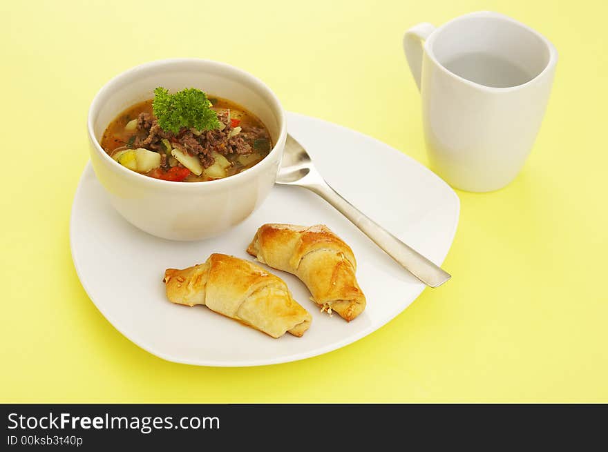 Lunch soup (vegetables and grounded meat) and baked cheese rolls