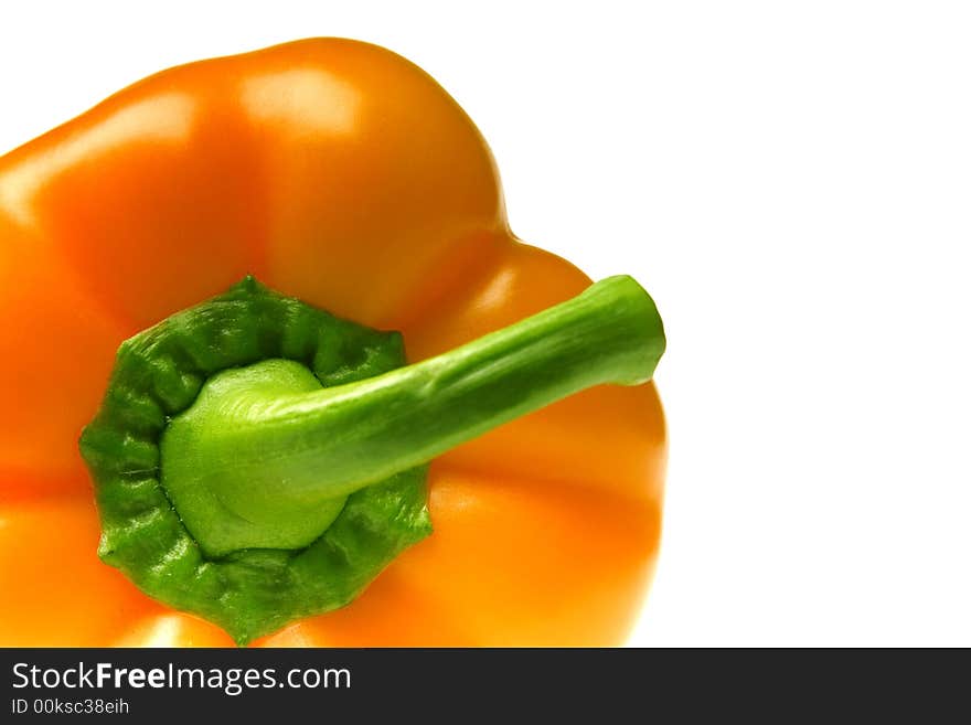 Excellent orange pepper with a green pod on a white background