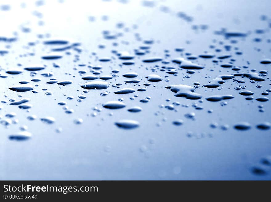 Texture from blue liquid drops on transparent glass