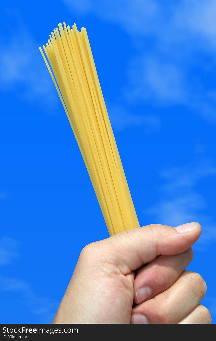 The Pasta Italiana in Hand / Isolated / Blue Sky Background / Little Clouds. The Pasta Italiana in Hand / Isolated / Blue Sky Background / Little Clouds