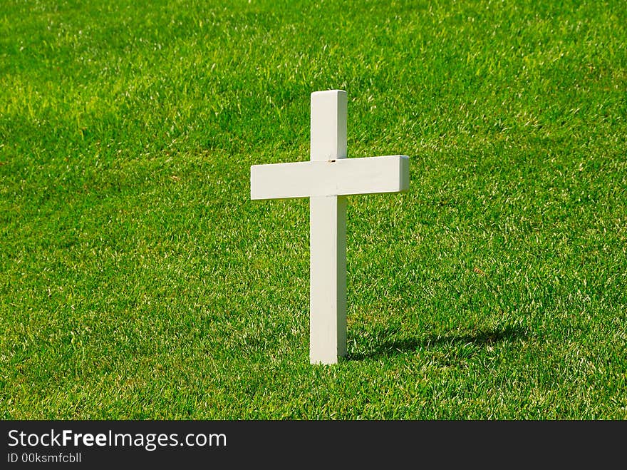 White Cross with a green grassy background.