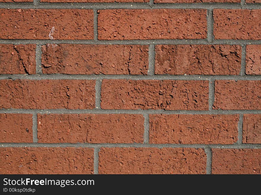 Red brick wall in the sun light, with gray mortar. Red brick wall in the sun light, with gray mortar