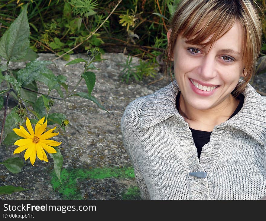 Girl in nature with yellow flower. Girl in nature with yellow flower