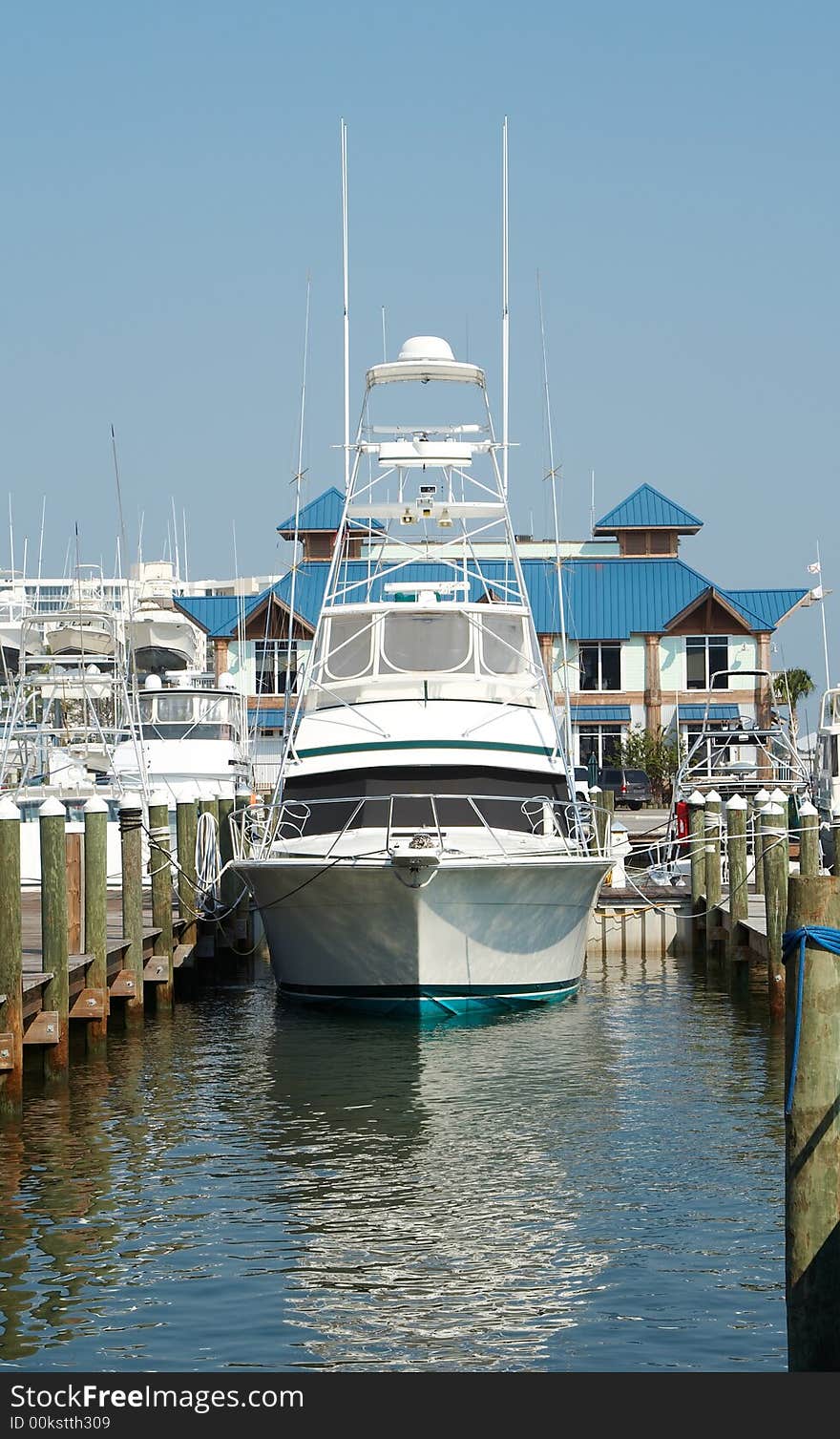 A vertical composition of a fishing boat in a marina. A vertical composition of a fishing boat in a marina.