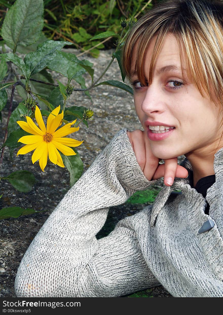 Girl in nature with yellow flower. Girl in nature with yellow flower