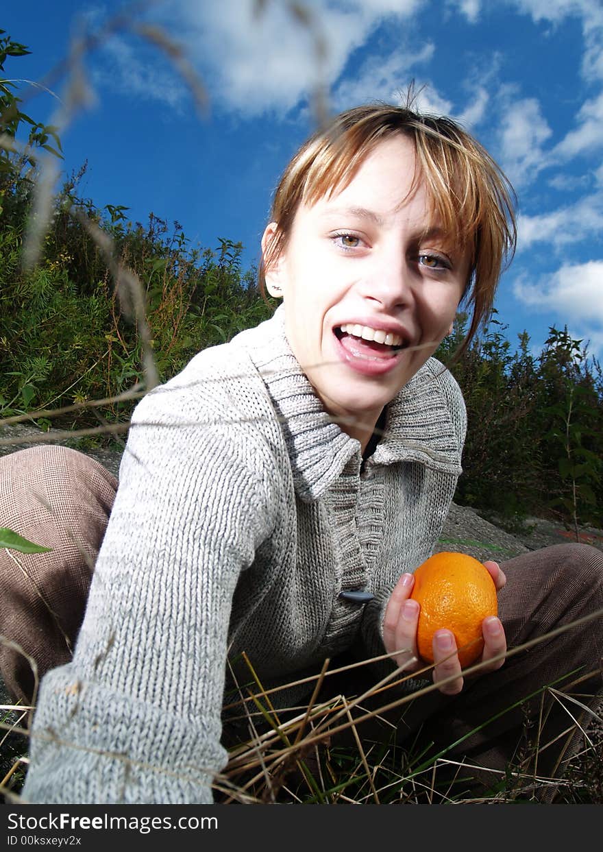 Girl in nature with orange. Girl in nature with orange