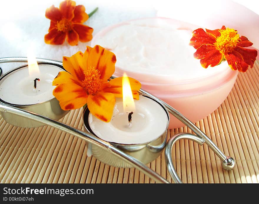 Cream And Candle With Flowers