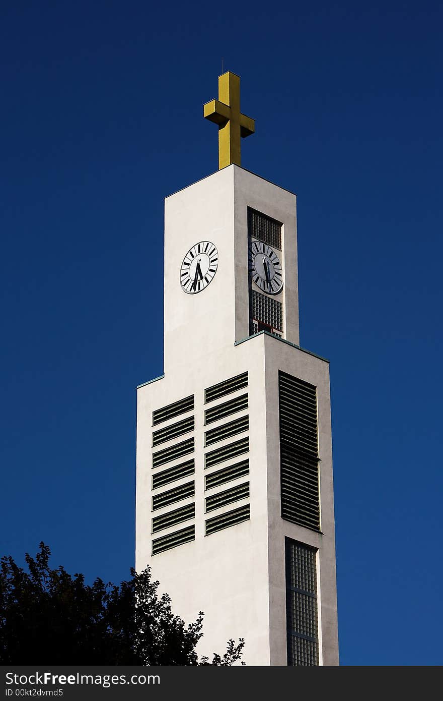 White tower of modern church, blue sky