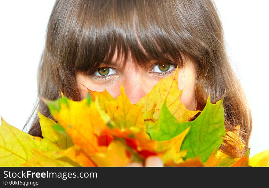 Girl with maple leaves isolated over white background. Shallow DOF, focus on the eyes.