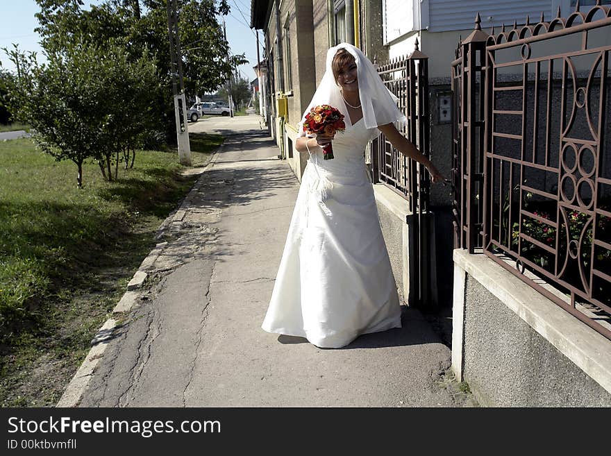 Bride smiling living her home before wedding