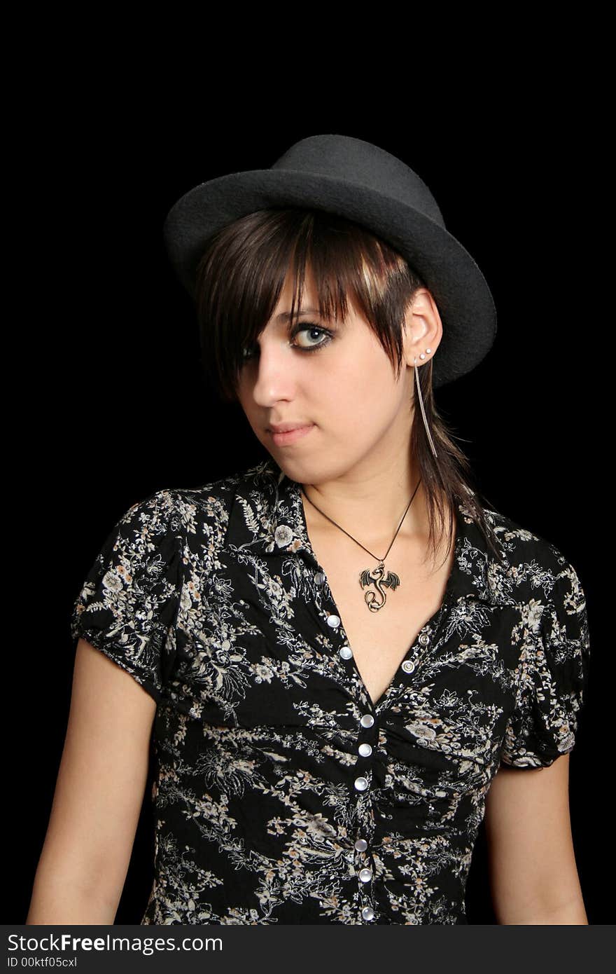 The young girl in a hat, on a black background