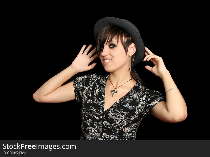 The young smiling girl in a hat, on a black background. The young smiling girl in a hat, on a black background