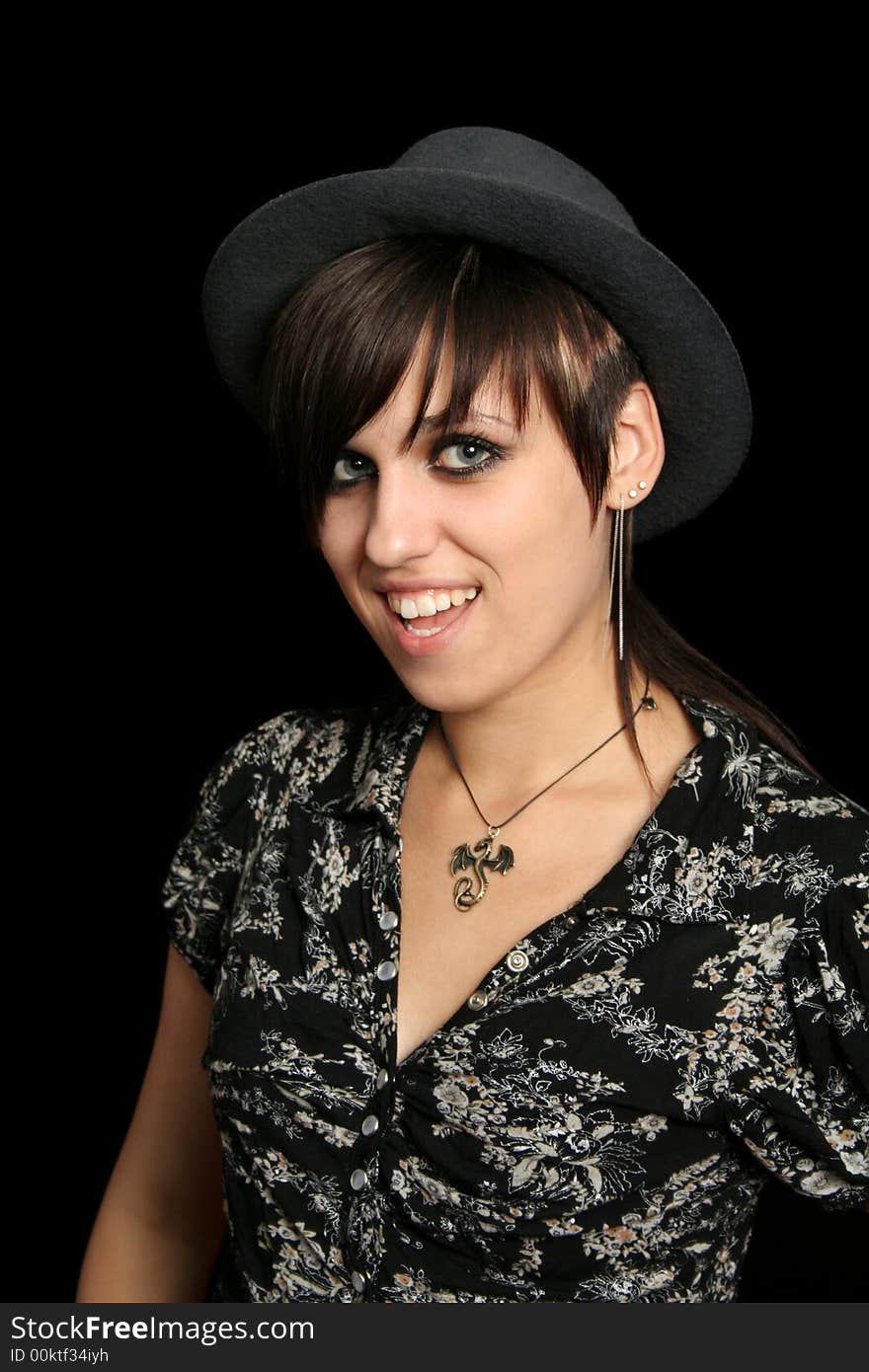 The young smiling girl in a hat, on a black background. The young smiling girl in a hat, on a black background