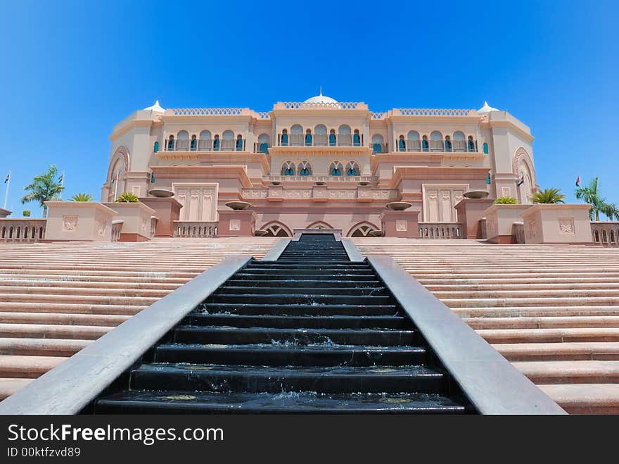 Ancient palace with ancient design far at the peak of the city with pure blue background