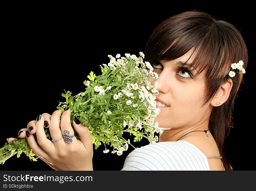 The young beautiful girl with flowers, isolated on a black background. The young beautiful girl with flowers, isolated on a black background