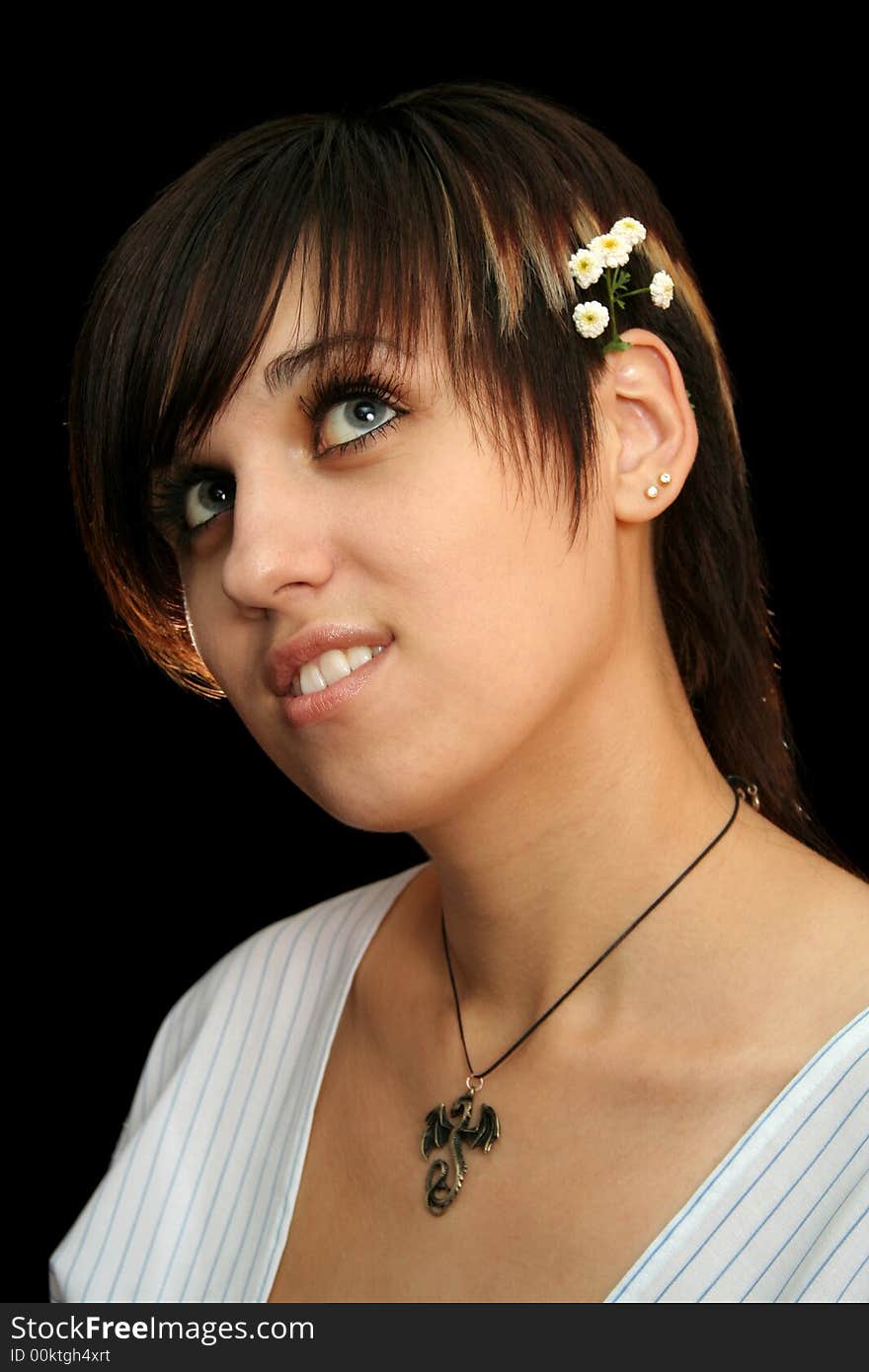 The young beautiful girl with flowers, isolated on a black background