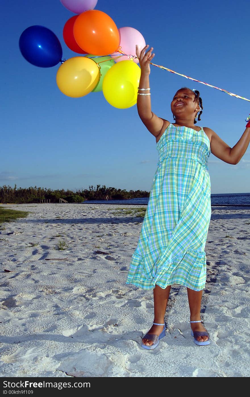 A smiling girl with ballons on the beach. A smiling girl with ballons on the beach