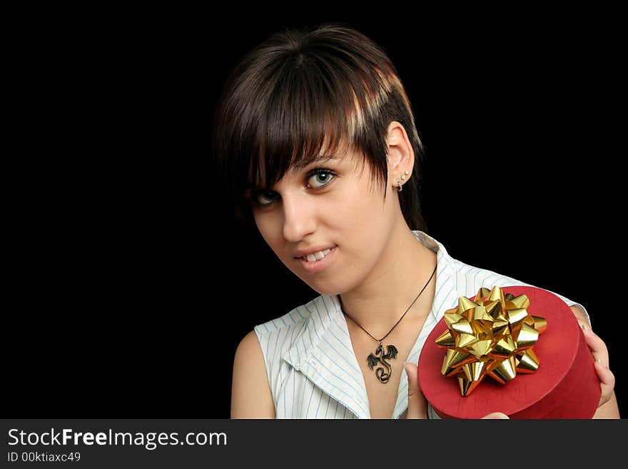 The young girl holds a box with a gift, isolated on black background. The young girl holds a box with a gift, isolated on black background