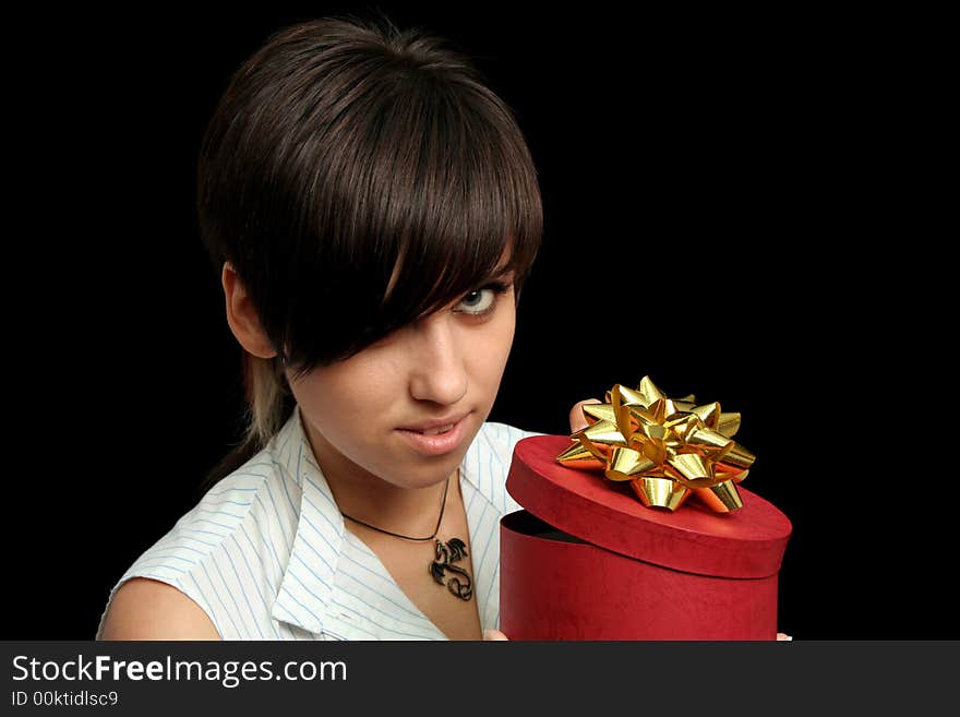 The young girl holds a box with a gift, isolated on black background. The young girl holds a box with a gift, isolated on black background