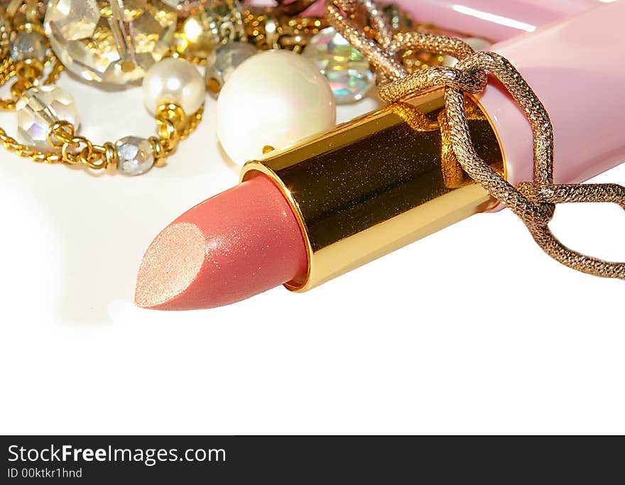 pink lipstick and beads closeup. pink lipstick and beads closeup