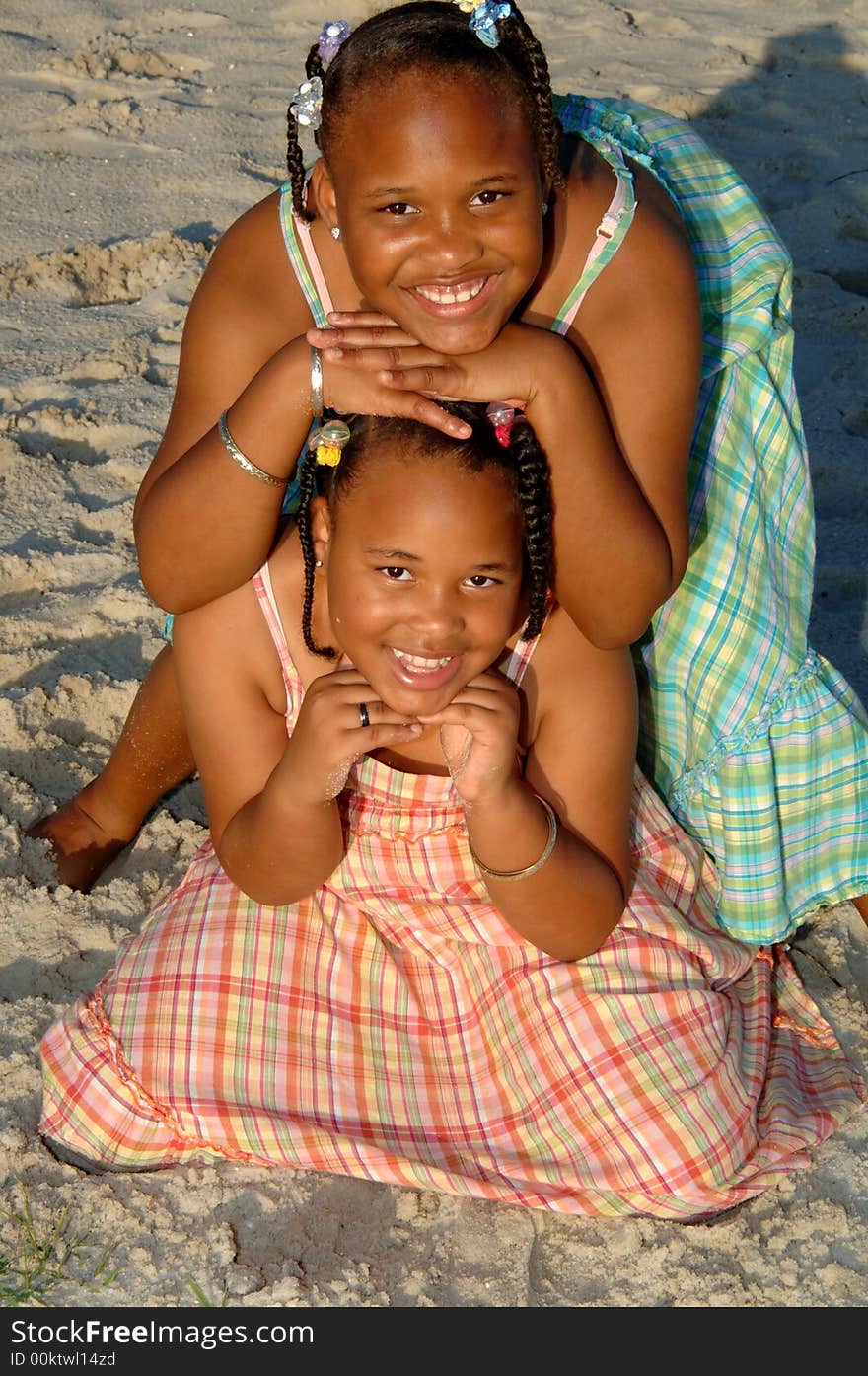 Two african american sisters posing outside on a beach. Two african american sisters posing outside on a beach