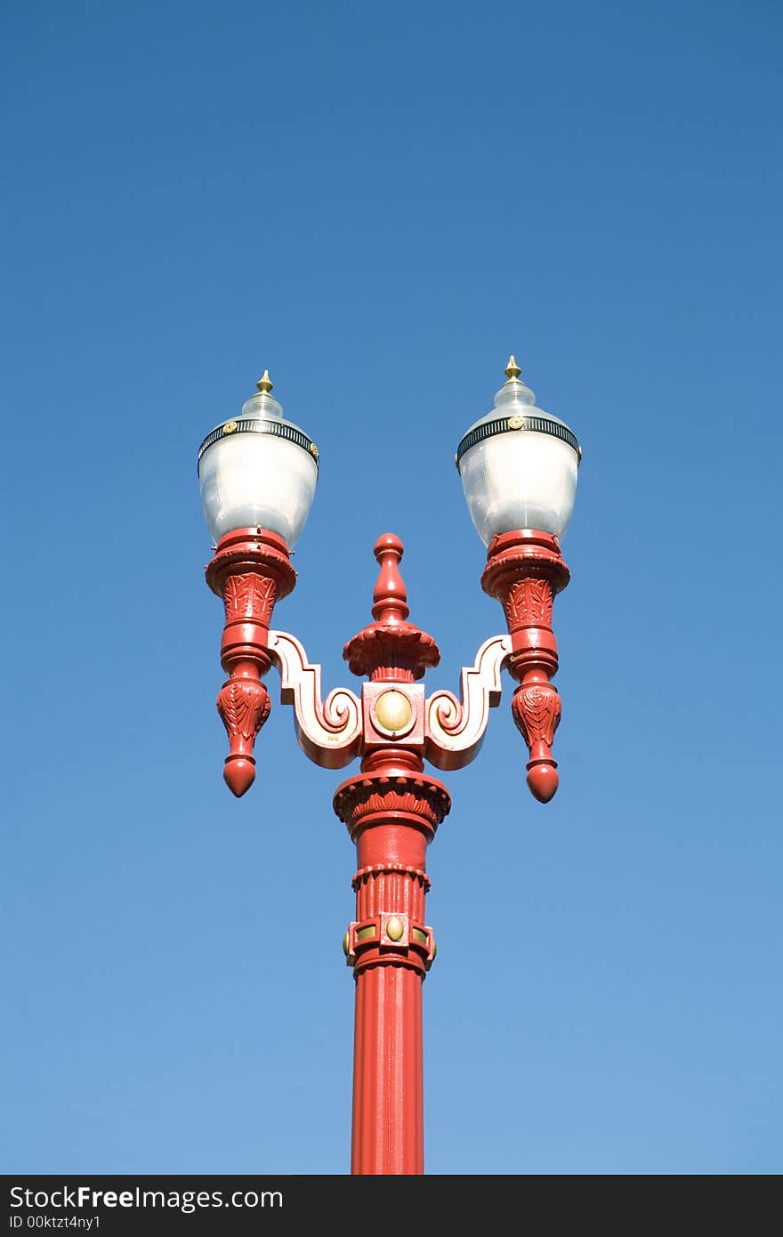 Red Gas Lamp Light against a blue sky