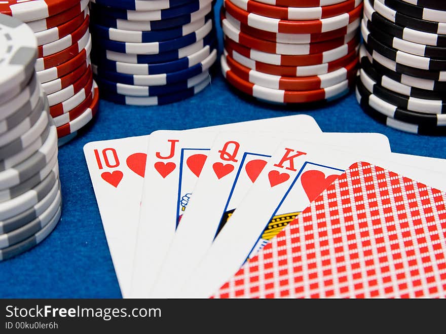 A possible royal flush with chips in background. A possible royal flush with chips in background