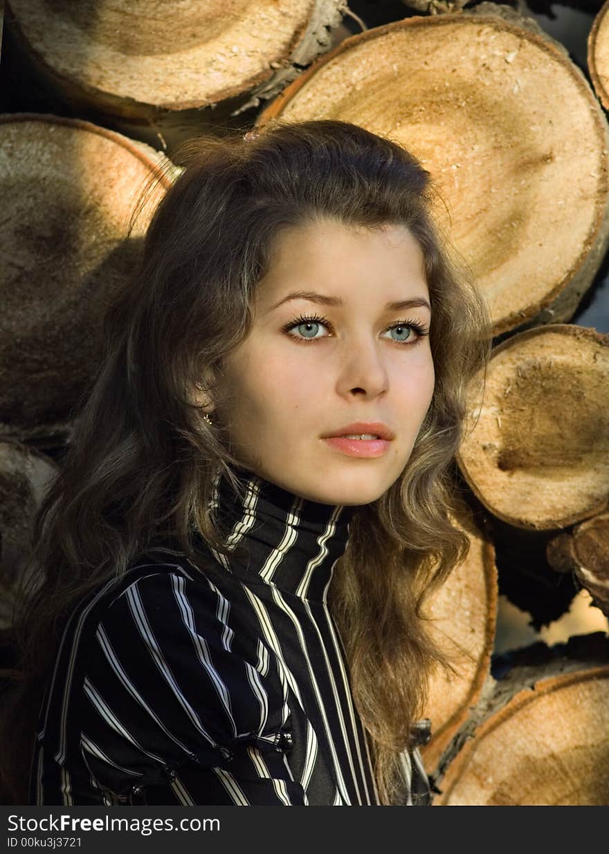 The girl near a solar woodpile. The girl near a solar woodpile