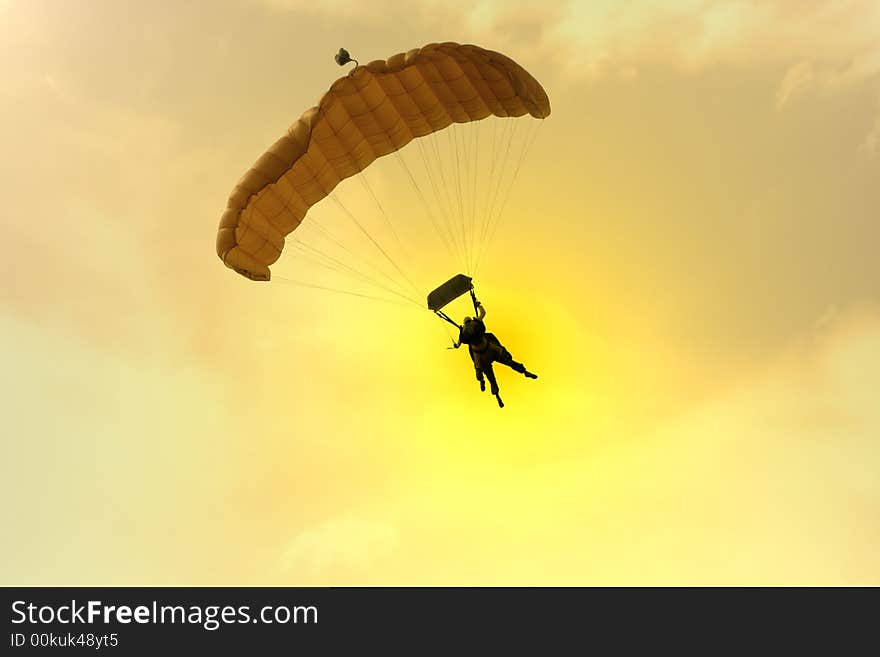 Two Parachuter's silhouettes at sunset