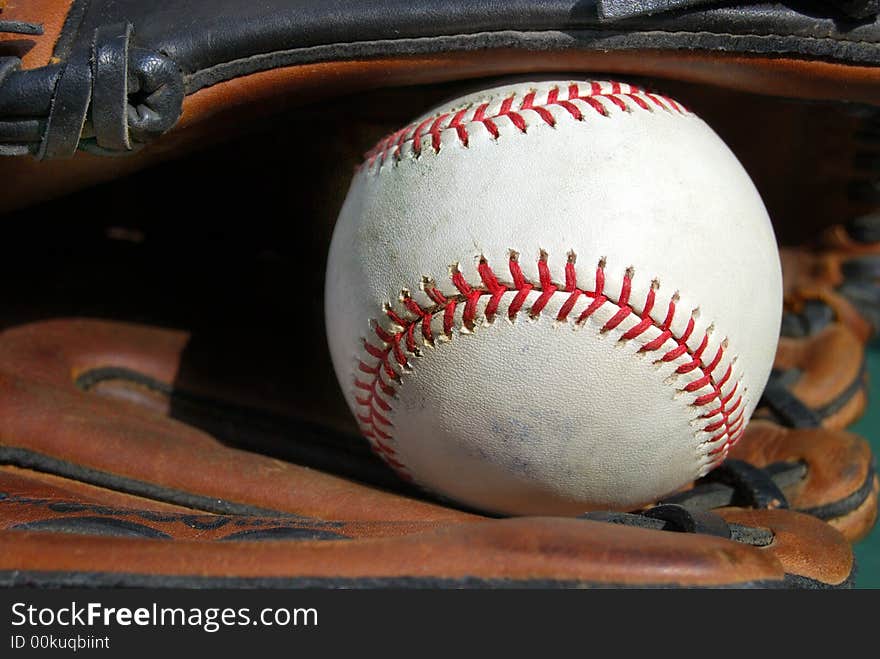 Baseball in the webb of glove. Baseball in the webb of glove