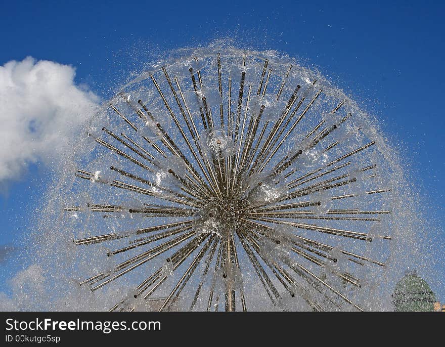 Water fountain on a background of the dark blue sky