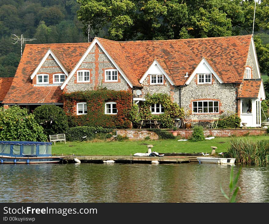 Riverside House on the Banks of the River Thames in England in early Autumn. Riverside House on the Banks of the River Thames in England in early Autumn