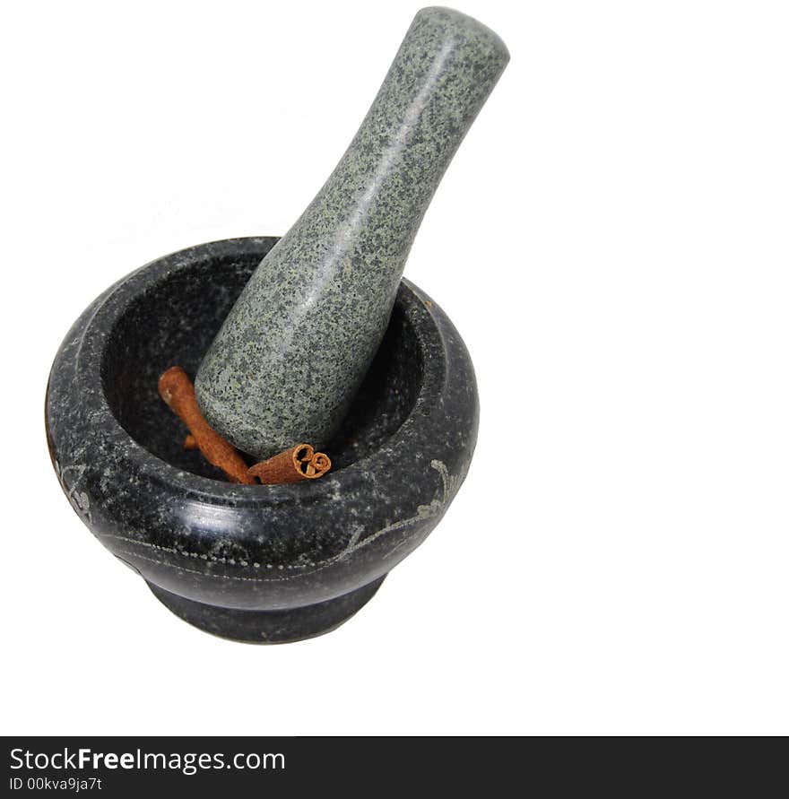 Sticks of cinnamon are being ground by mortar and pestle. Sticks of cinnamon are being ground by mortar and pestle.