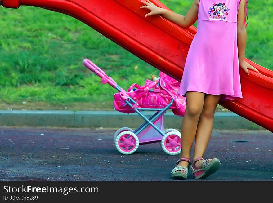 Young girl playing a mother at the playground. Young girl playing a mother at the playground