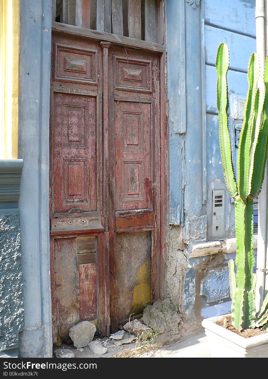 Old door to old house, with cactus plant outside. Old door to old house, with cactus plant outside